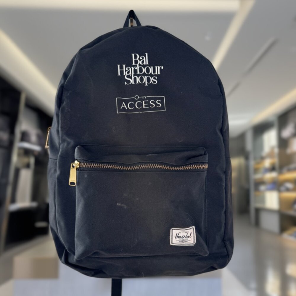 Black Herschel Supply Co. Backpack with "Bal Harbour Shops ACCESS" branding